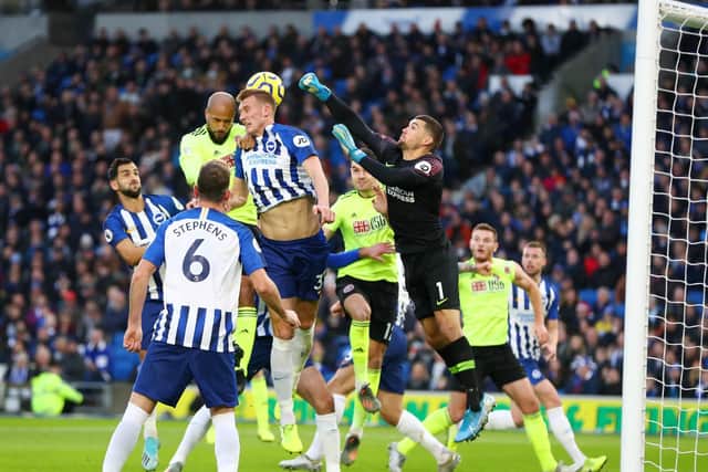 Brighton and Hove Albion goalkeeper Maty Ryan struggles to deal with a corner from Sheffield United