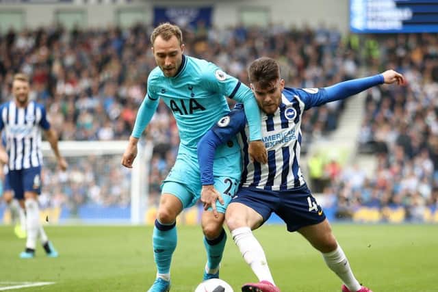 Aaron Connolly takes on Tottenham playmaker Christian Eriksen