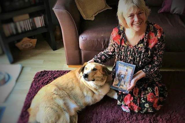 Lisa Edwards with her three-legged rescue dog and his book Ouzo the Greek
