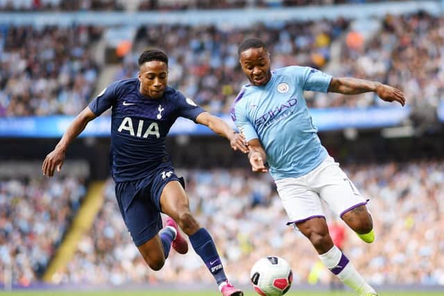 Kyle Walker-Peters (left) keeps a close watch on Manchester City's Raheem Sterling