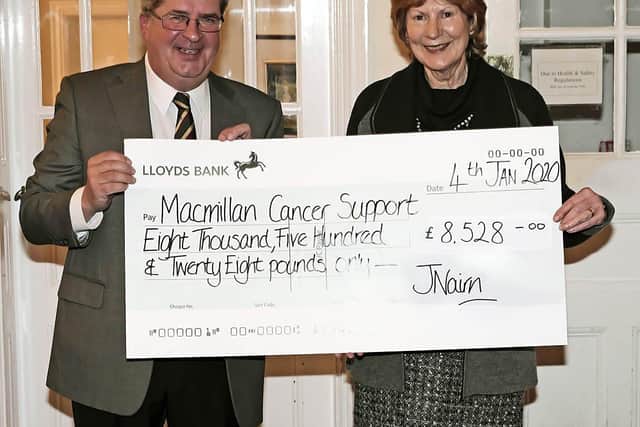 A representative of Macmillan Cancer Support accepting a cheque at Crowborough Beacon Golf Club's AGM