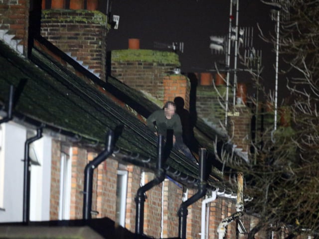 He was throwing tiles off the roof into the road during two hours of negotiation.