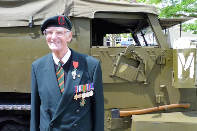 Don Puttock, pictured by an American Half Track - a military vehicle he drove during World War Two. Photo courtesy of the Royal British Legion