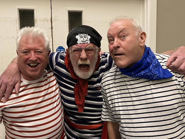 The crew grin for a photo