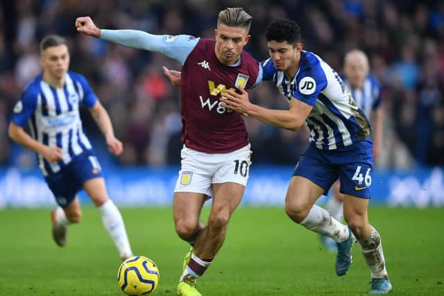 Jack Grealish and Steven Alzate tussle for possession
