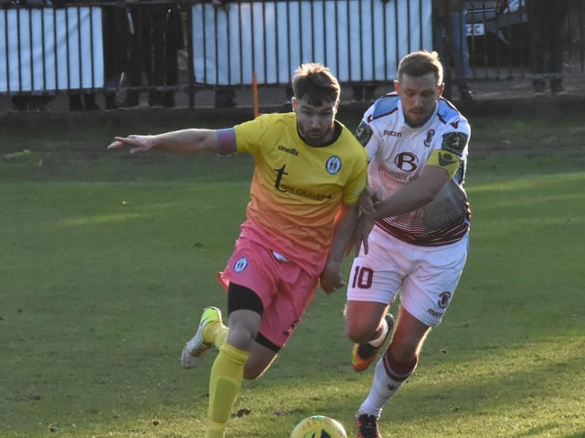 Lloyd Cotton battles for the ball.