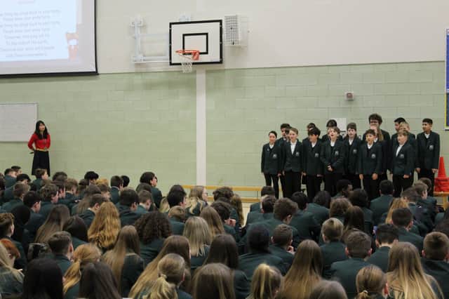 Mandarin Excellence Programme students singing at the school assembly