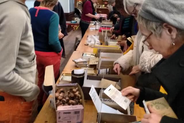 Gardeners browse seeds and bulbs at a previous Lewes Seed Swap