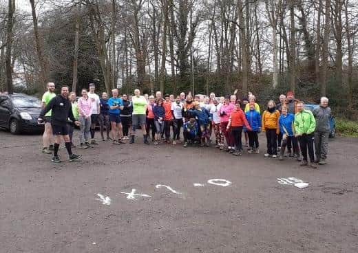 Members of East Grinstead Hash House Harriers (EGH3) standing in front of flour markings before a summer run