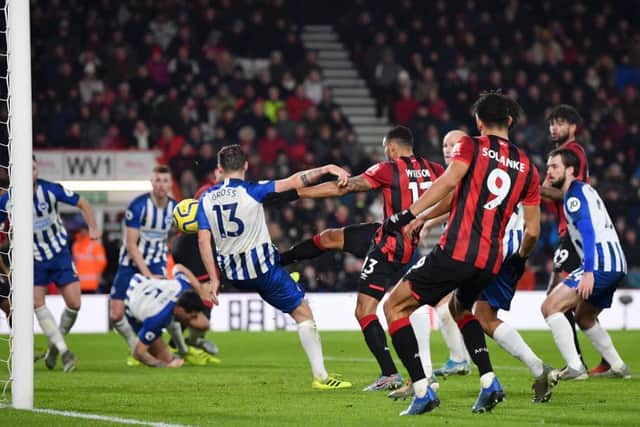 Brighton and Hove Albion concede the second goal as Pascal Gross turns the ball into his own net while under pressure from Callum Wilson
