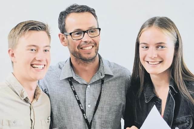 Chatsmore Catholic High School head teacher Peter Byrne with Kieran Malandain and Jessica Hurley in the summer, when they received their GCSE results