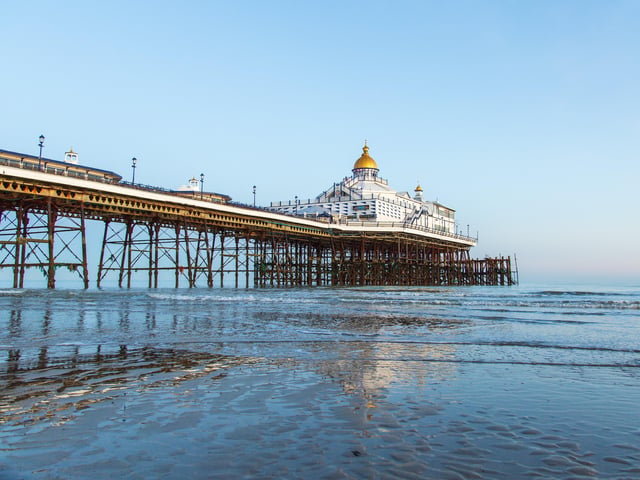 Eastbourne pier, at very low tide and all lit up by winter sunshine. This photograph was taken by Barry Davis, using a Canon 5d iii SUS-200130-093640001