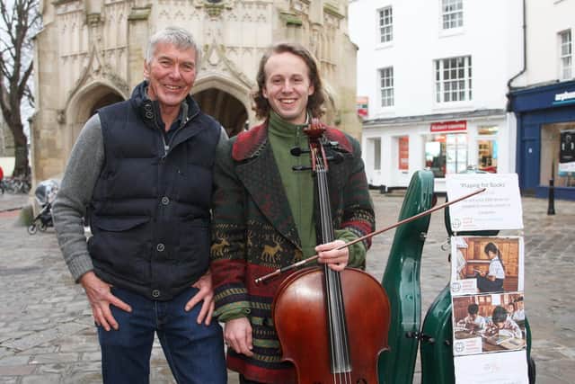 DM2022203a.jpg Chichester busker Will Dodd raises ?1,000 for Cambodia charity.Pictured with Chris Howarth (charity founder). Photo by Derek Martin Photography SUS-200218-190800008