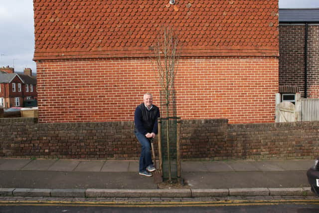 Councillor Peter Diplock poses with one of the new trees