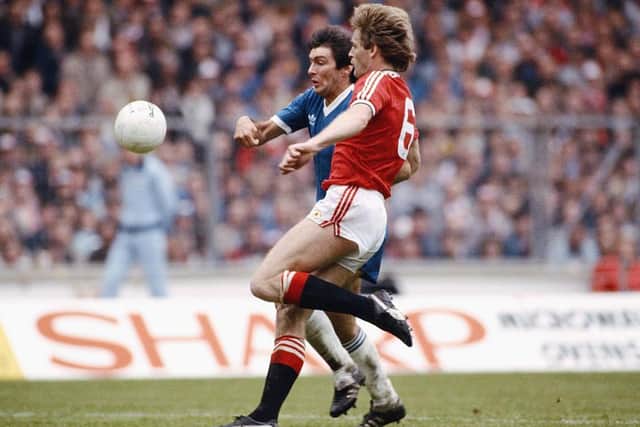Brighton striker Gordon Smith is challenged by Manchester United defender Gordon McQueen during the 1983 FA Cup Final at Wembley