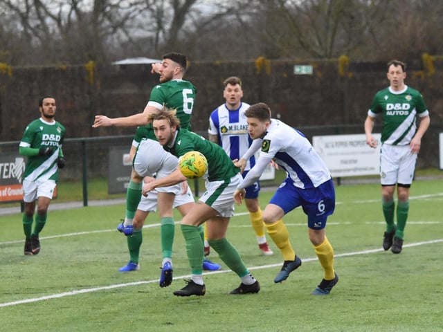 Josh Spinks heads the ball away