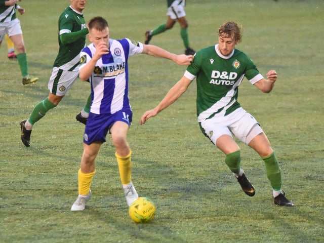 Keiran Rowe pokes the ball away from a defender