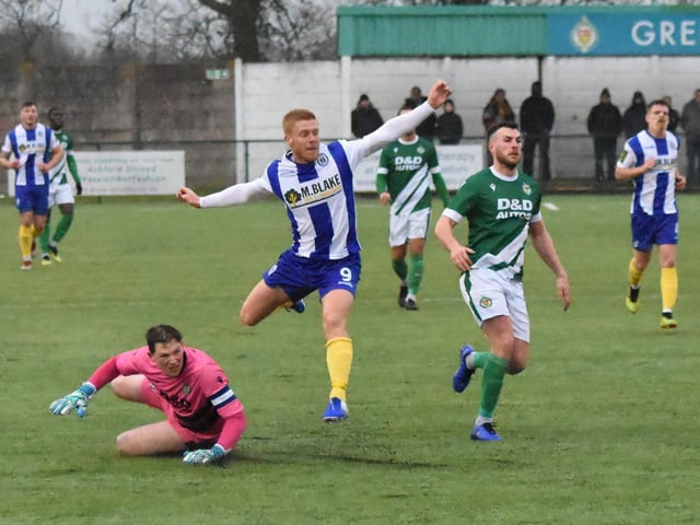 Trevor McCreadie jumps over the Ashford keeper