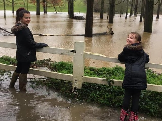 Samantha Robbins' daughters Jess (11) and Summer (8) admiring the flooding in Warrs Hill Lane, Lewes SUS-200216-162856001