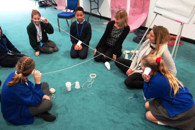 Using plastic cups and string for a listening activity