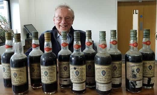 Charles Metcalfe with the bottles of rum he inherited from his late father SUS-200220-161646001