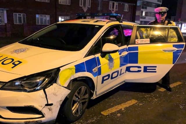 PC James King, of the Roads Policing Unit, with the damaged police car