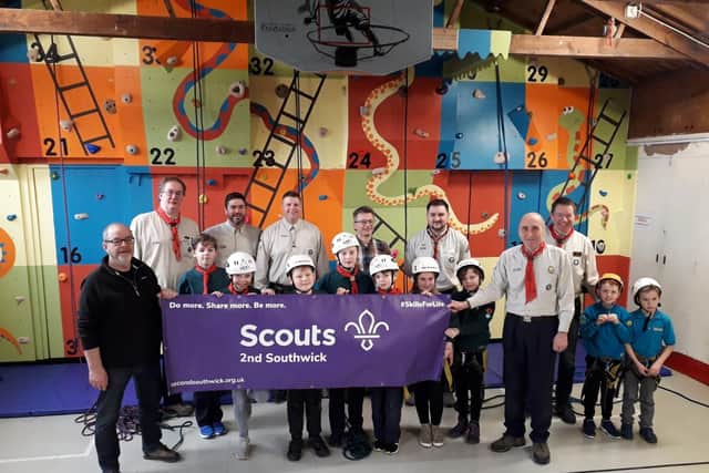 Nick Reeve and Stan Furlong, who designed and built the climbing wall, celebrate the opening with 2nd Southwick Scout Group