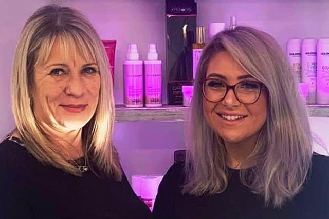 Good Salon Guide area sales manager Denise Horn, left, presents Charlotte Golby with her five-star rating