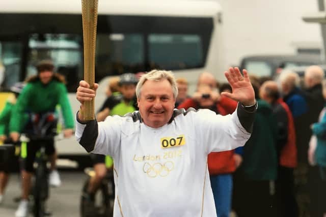 Chris Shore from East Preston holding the Olympic torch in 2012