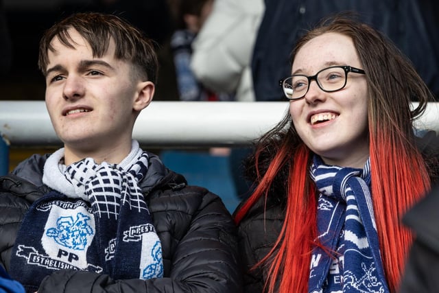 Two fans wear their PNE scarves with pride