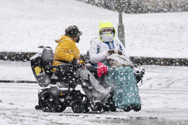 Two people wrap up in the heavy snow that hit York on Saturday