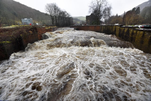 The River Calder swollen by persistent heavy rain at Sandbeds, car Todmorden, West Yorkshire. [Image: Asadour Guzelian]