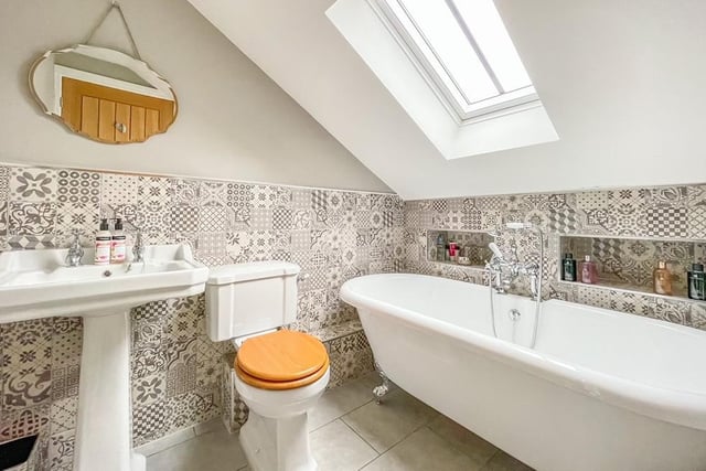 A free standing bath with central feature mixer tap has pride of place in this bathroom.