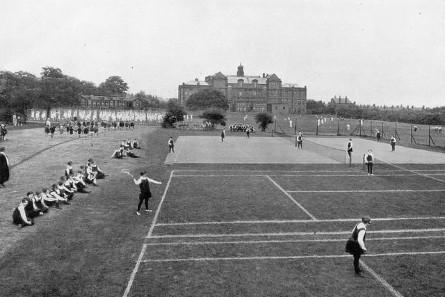 A view of the sports fields behind the old building of West Leeds High School in the 1940s. A variety of sports activities are taking place.