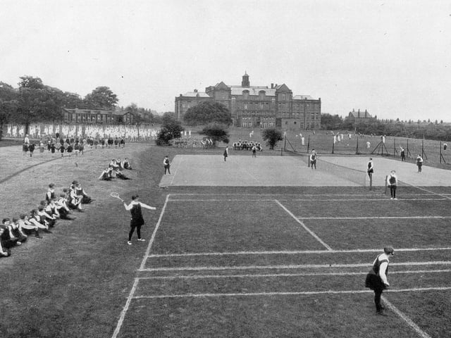 A view of the sports fields behind the old building of West Leeds High School in the 1940s. A variety of sports activities are taking place.