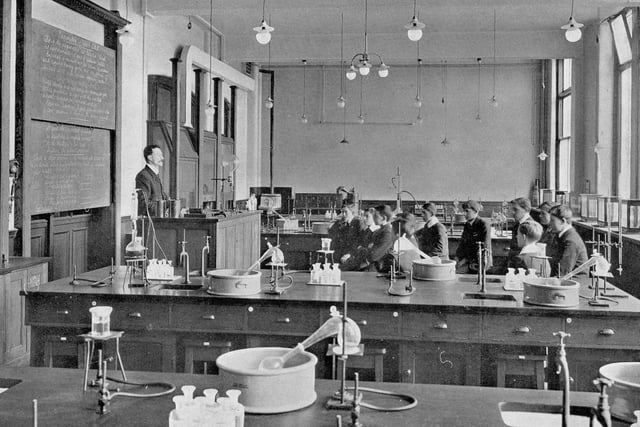 A chemistry laboratory in the boy's section of West Leeds High School in the 1940s. In the foreground can be seen benches equipped with sinks, gas taps, Bunsen burners, and other chemistry equipment.