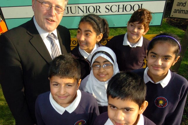 Headteacher Geoff Smith with year 6 pupils from Headfield Junior School, Dewsbury, celebrating a good OFSTED report.