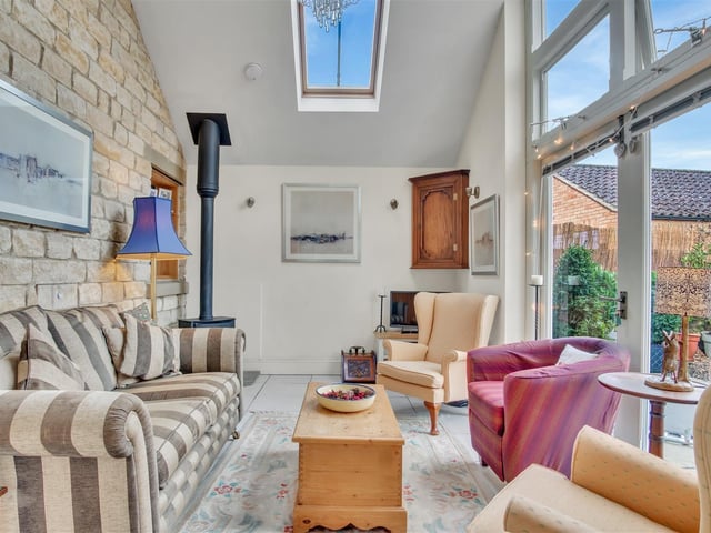 This garden room or conservatory has patio doors leading outside.