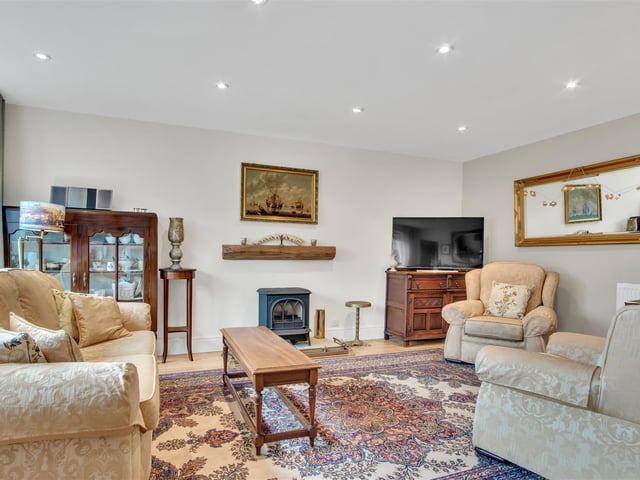 A stove adds the cosy factor to this reception room within the property.