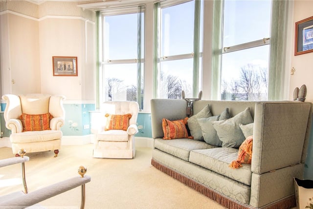 Natural light fills the elegant lounge through its large windows, that showcase the views beyond.