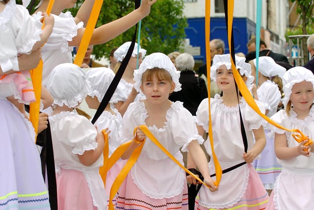 Children from the Castleford Dance Troupe dance around the maypole, in the new Henry Moore Square, Castleford.