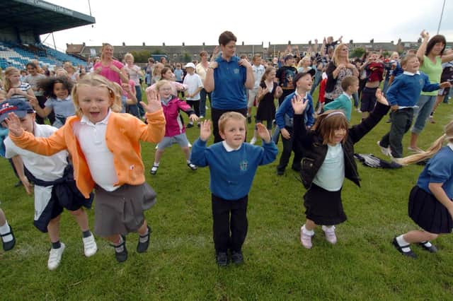 Participants in the World Record attempt for the most people doing the Haka and the Cha Cha Slide at Featherstone Rovers ground.