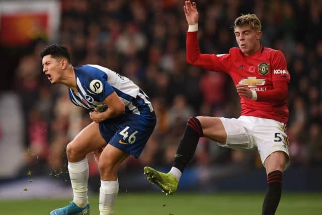 Brighton midfielder Steven Alzate takes a hefty blow against Manchester United at Old Trafford