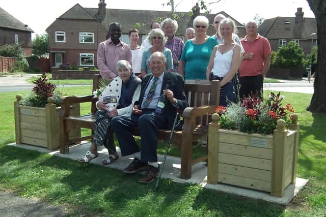 Mary and Doug Medhurst sit alongside the planters bearing their names in East Preston and the unveiling ceremony in 2013