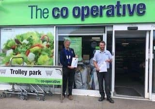 Bognor Regis Lions Club president Richard Johns presents the thank you notice to John Tyson, manager of The Co-operative Food shop in Rose Green