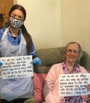 Elizabeth Wilton, 92, shares two of the messages, with the help of a staff member at Abbotswood in Rustington