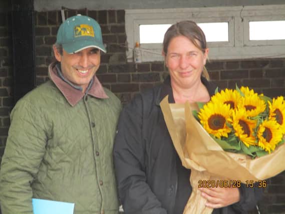 Suzy Smith and Sergio Gordon-Watson with flowers presented by the Lewes Racecourse History Group