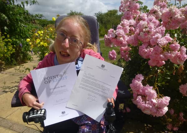 Lizzie Baily with her letter and Points of Light certificate from Prime Minister Boris Johnson