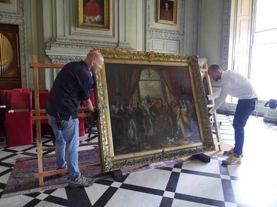 Reinstalling a painting at Petworth House