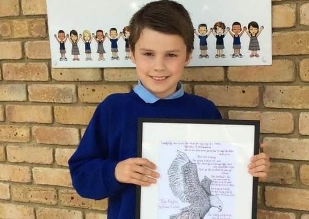 Fraser Labate, a pupil at Holbrook Primary School, with his winning poem SUS-200721-104541001